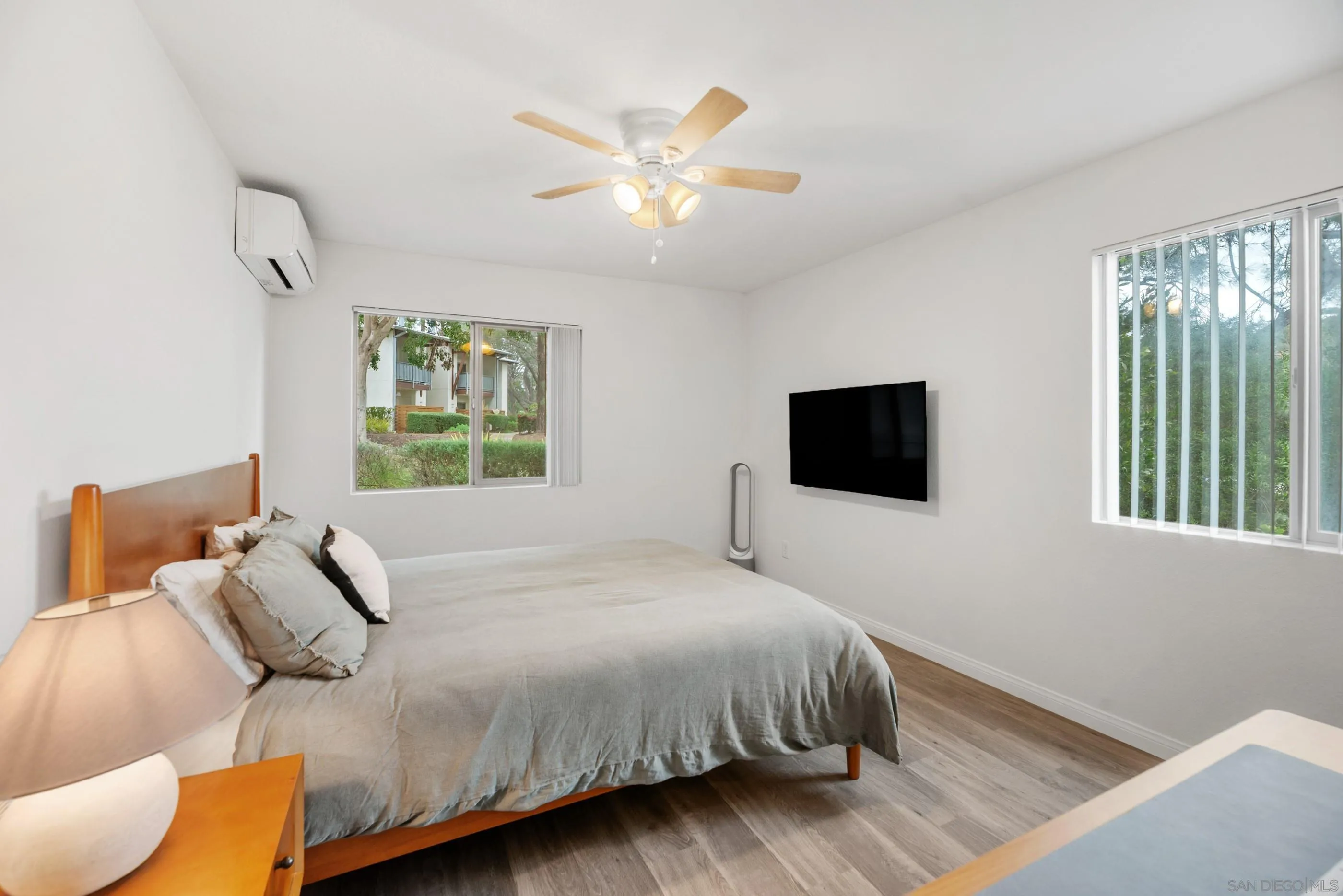 1810 South El Camino Real, Unit 101 Encinitas, CA 92024 - Photo 19 of 39 a bedroom with a large bed and a window