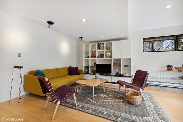 a living room with furniture a fireplace and a table