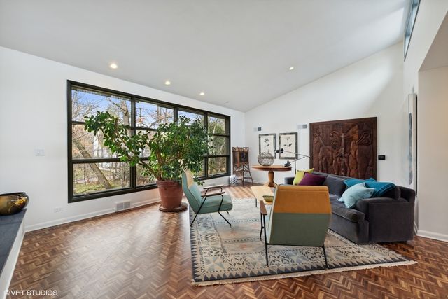 a living room with furniture large window and flat screen tv