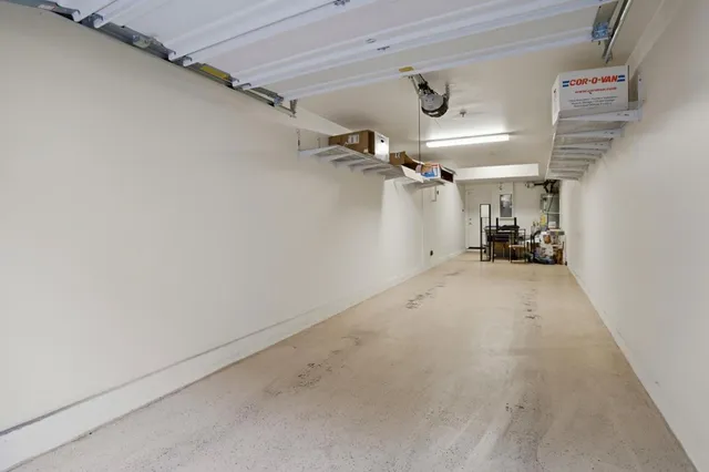 a view of a house with backyard and a tree