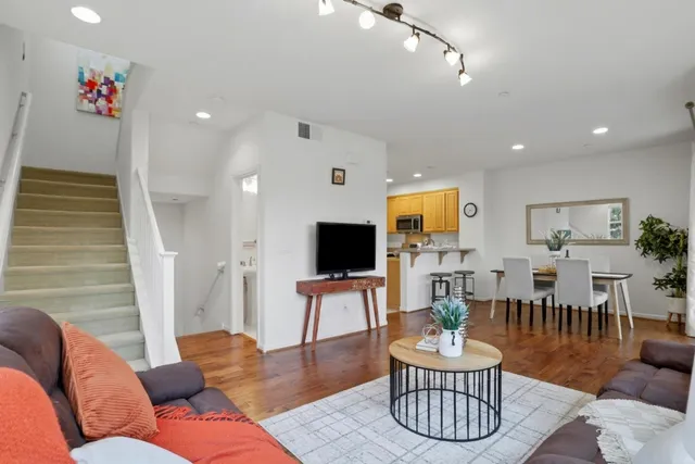 a kitchen with granite countertop a sink a stove a microwave and cabinets