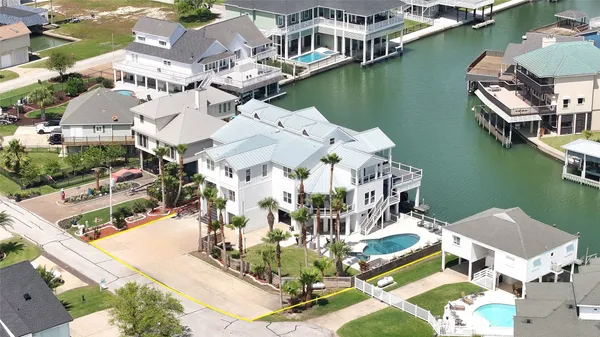 an aerial view of a house with outdoor space lake view and boat