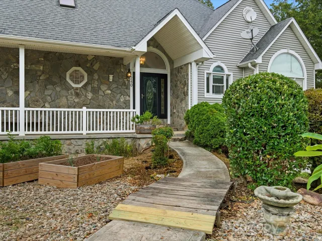a view of a house with a yard and a garden