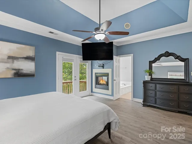 a bedroom with a bed a flat screen tv and a dresser