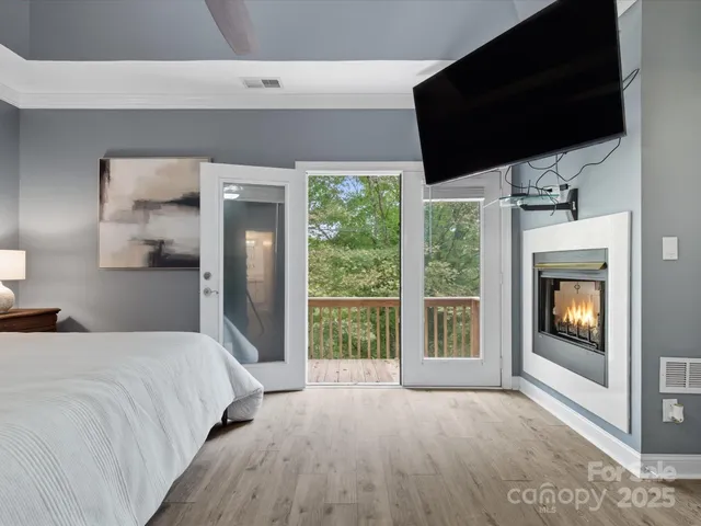 a bedroom with a bed and a television