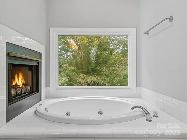 a bathroom with a tub and window