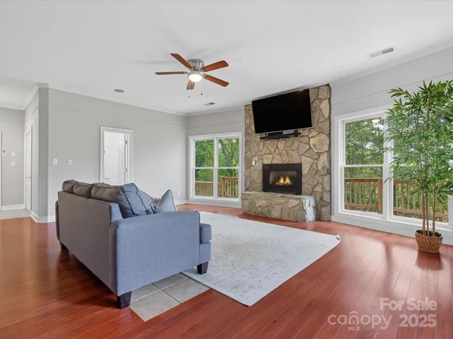 a living room with furniture fireplace and flat screen tv