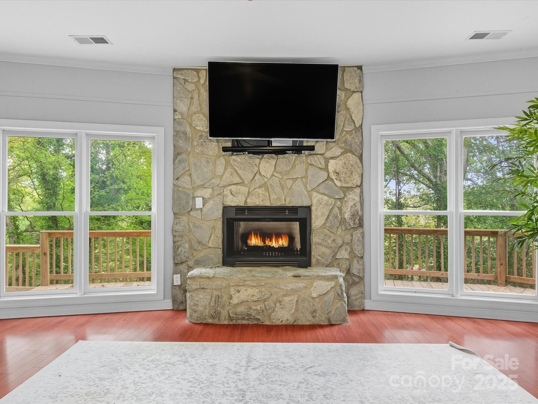 240 Petty Road Gastonia, NC 28056 - Photo 30 of 48 a living room with fireplace and a flat screen tv