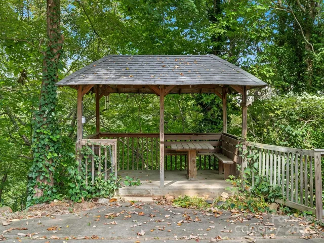 a view of patio with a table and chairs under an umbrella