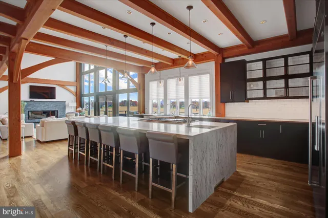 a view of a hallway with wooden floor and a window