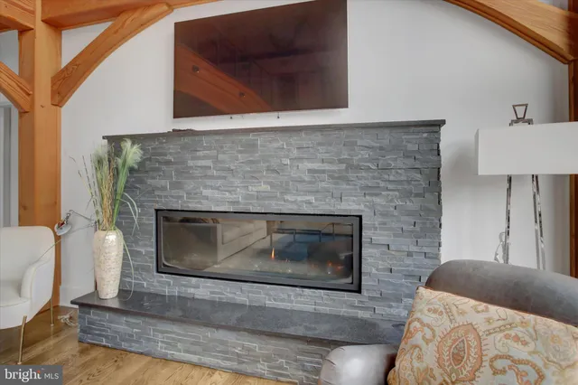a spacious bedroom with a bed and painting on the wall