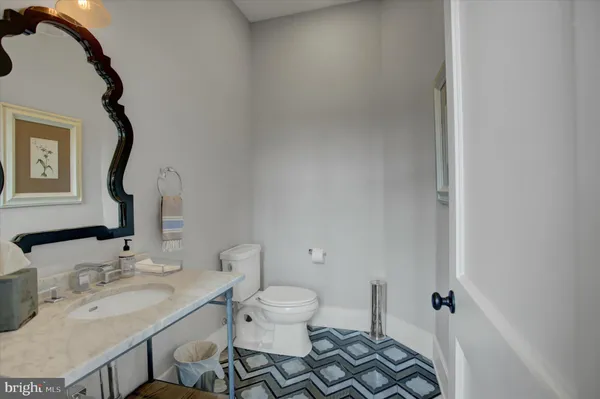 a bathroom with double vanity sinks granite vanity and a mirror
