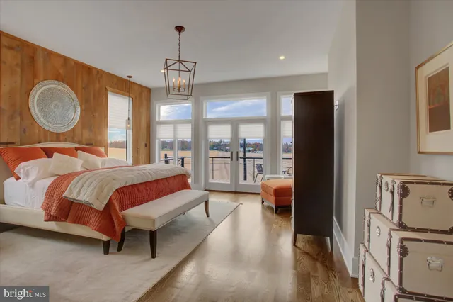 a living room with furniture stove and wooden floor