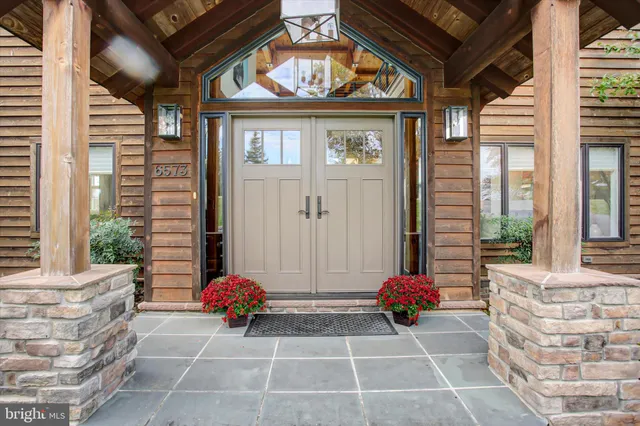 a dining hall with stainless steel appliances granite countertop a stove and a large window