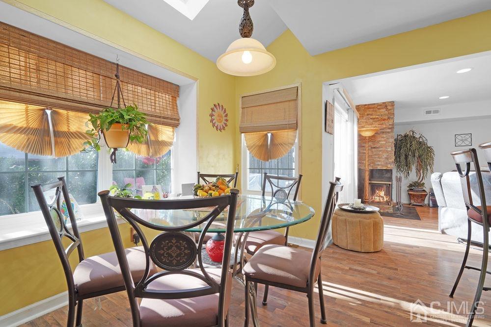 71 Winchester Way Somerset, NJ 08873 - Photo 11 of 24 a dining room with furniture a chandelier and wooden floor