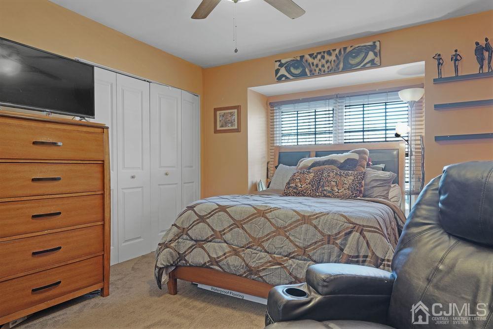 71 Winchester Way Somerset, NJ 08873 - Photo 14 of 24 a bedroom with a bed and a flat screen tv