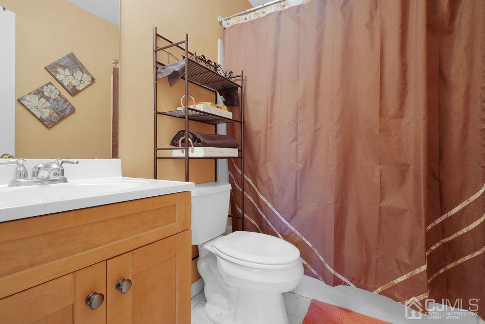 71 Winchester Way Somerset, NJ 08873 - Photo 15 of 24 a bathroom with a sink a toilet and shower curtain