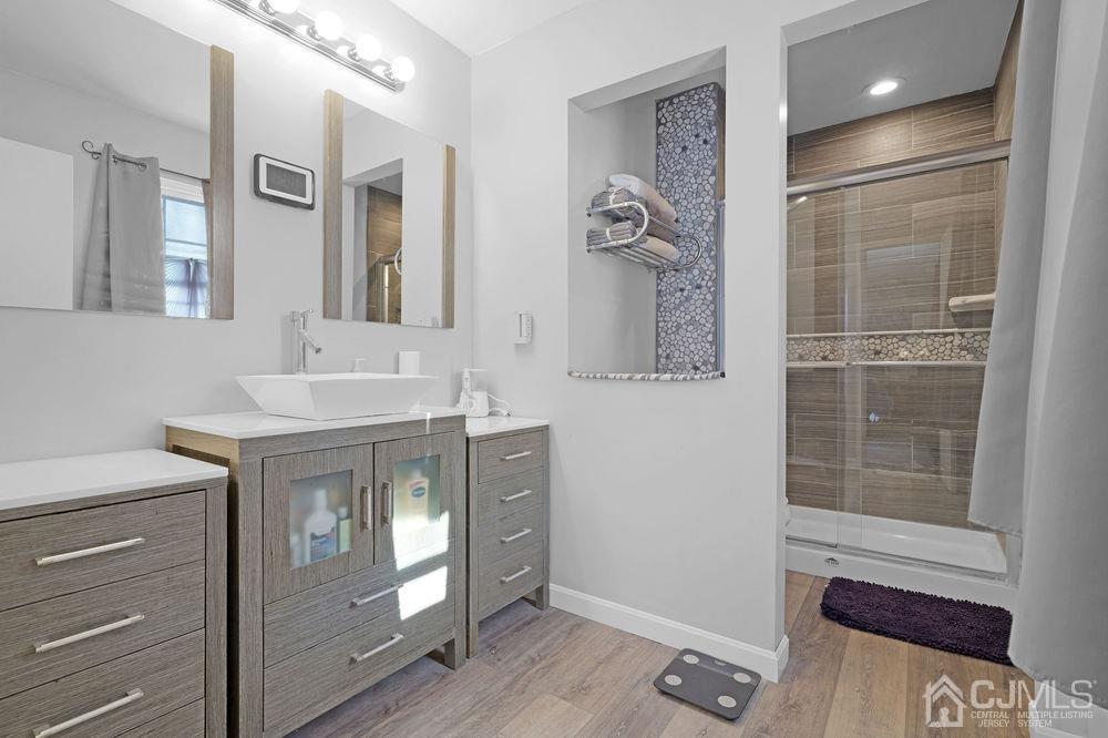 71 Winchester Way Somerset, NJ 08873 - Photo 18 of 24 a bathroom with a sink vanity and a mirror