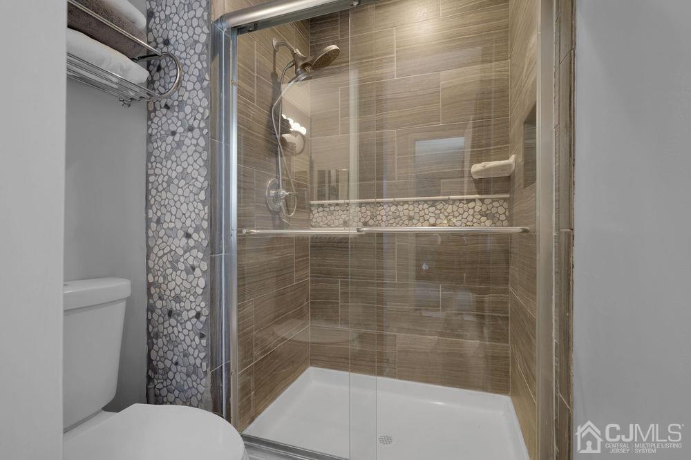 71 Winchester Way Somerset, NJ 08873 - Photo 19 of 24 a bathroom with a shower and a toilet