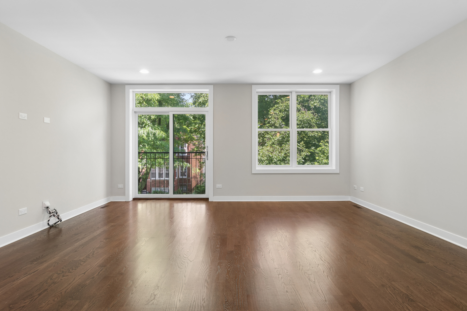 4845 North Keystone Avenue, Unit 2N Chicago, IL 60630 - Photo 3 of 21 a view of an empty room with wooden floor and a window