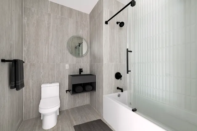 a bathroom with a toilet a sink a tub and shower