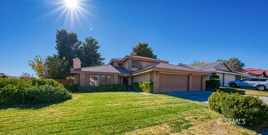 223 West Cobblestone Lane Ridgecrest, CA 93555 - Photo 32 of 34 a front view of a house with a garden