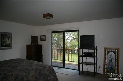 7555 Kennedy Road Sebastopol, CA 95472 - Photo 9 of 11 a bedroom with a bed and a television