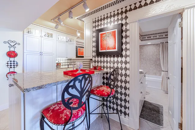 a bedroom with a bed and a lamp on dresser