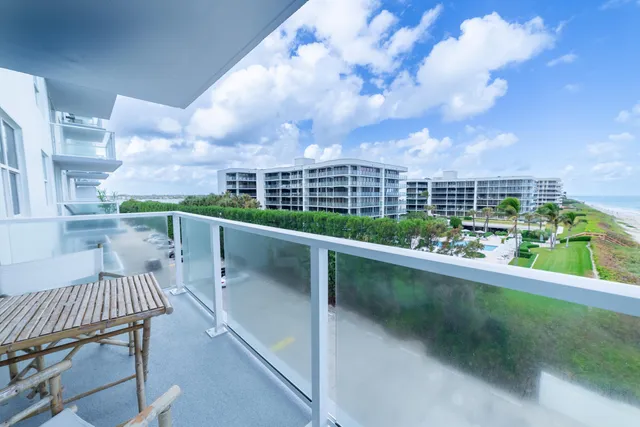 a dining room with wooden floor a chandelier a wooden table and chairs