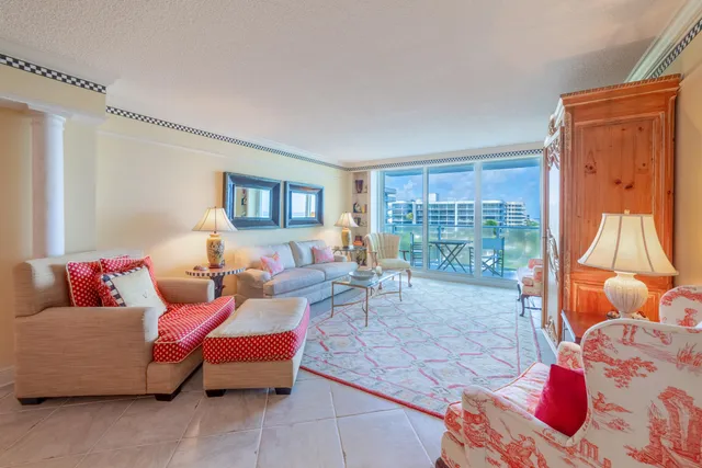a living room filled with furniture and a glass door