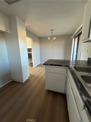 a kitchen with granite countertop a stove and a refrigerator