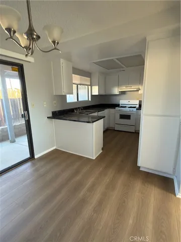 a kitchen with stainless steel appliances a sink a stove a refrigerator and cabinets