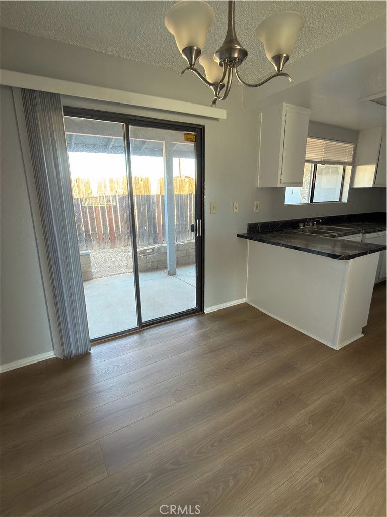 10547 Cochiti Road Apple Valley, CA 92308 - Photo 6 of 10 a view of a kitchen with a sink and wooden floor