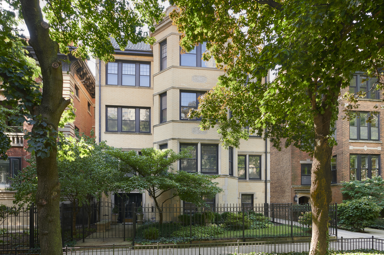 a front view of a house with a yard and trees