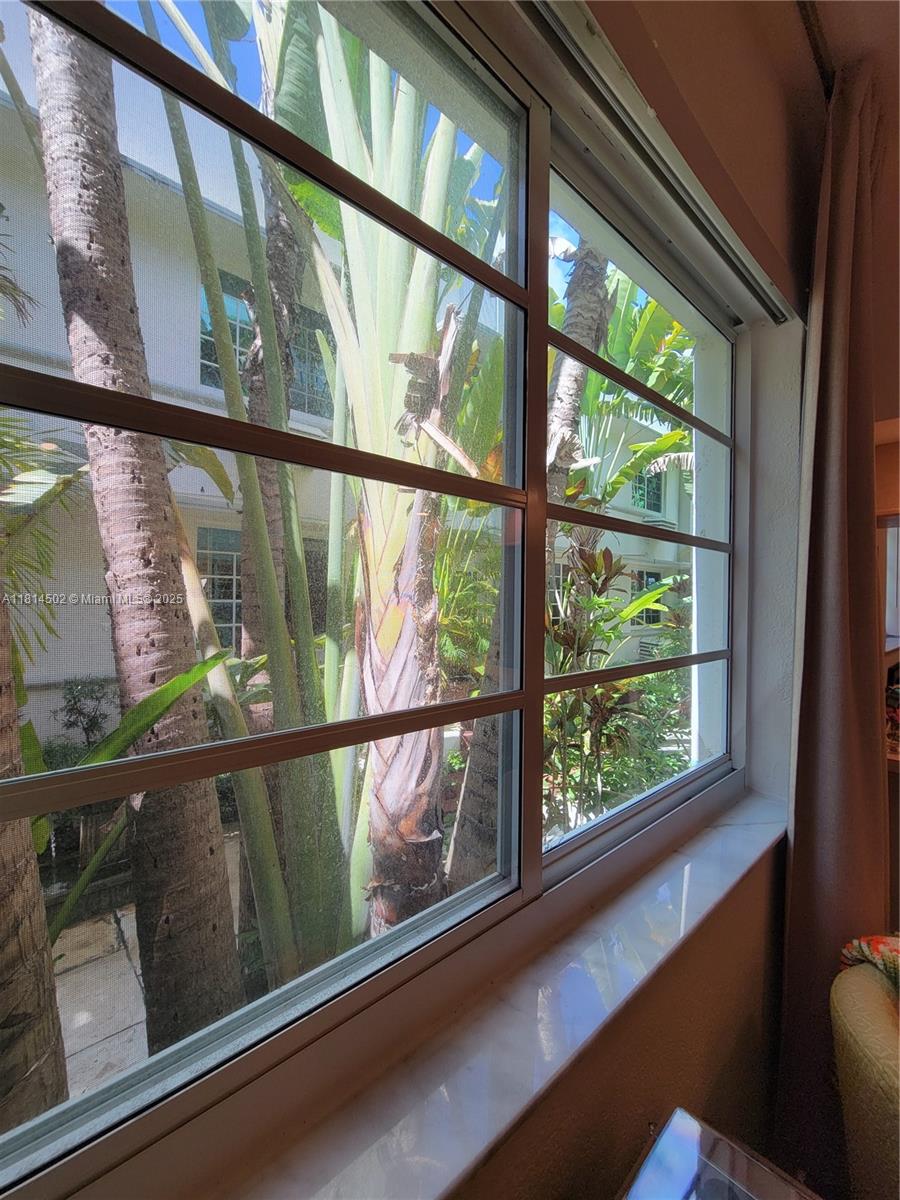 359 Meridian Avenue, Unit A103 Miami Beach, FL 33139 - Photo 12 of 22 a view of a glass door with a bench
