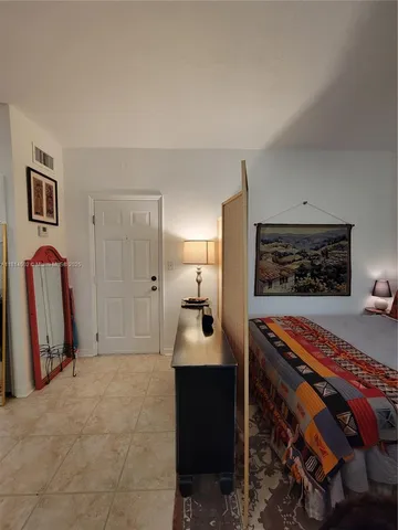 a bedroom with a bed and a mirror