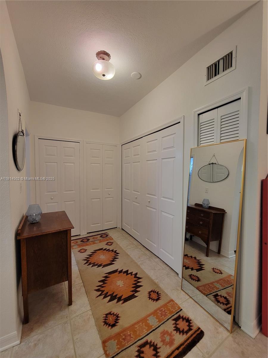 359 Meridian Avenue, Unit A103 Miami Beach, FL 33139 - Photo 15 of 22 a bedroom with a bed and a mirror