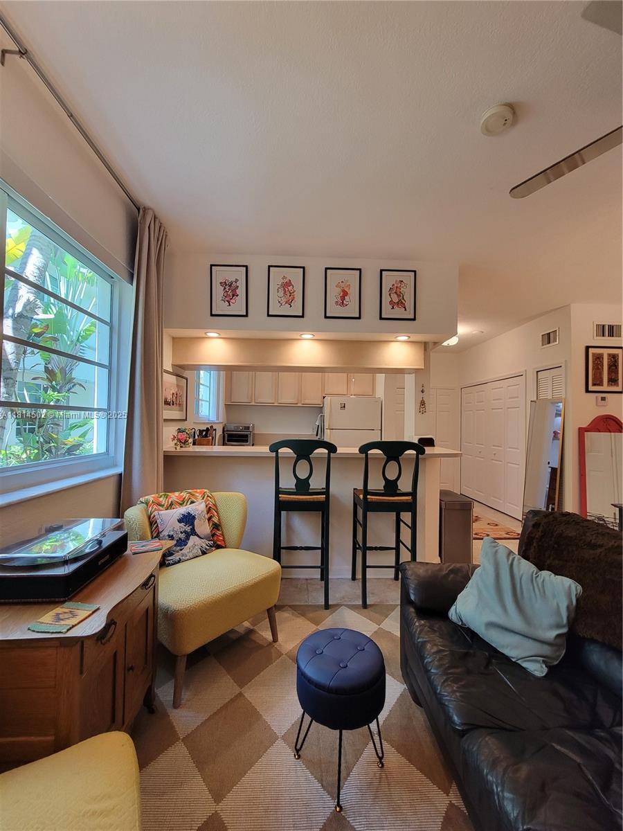 359 Meridian Avenue, Unit A103 Miami Beach, FL 33139 - Photo 7 of 22 a living room with furniture and a window