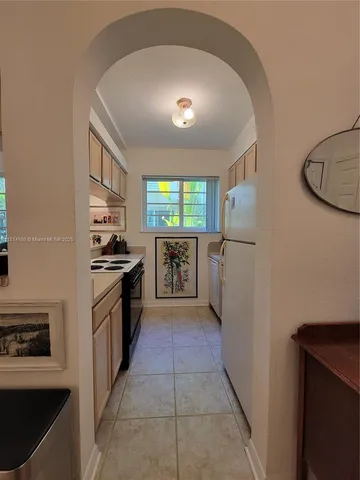 a kitchen with stainless steel appliances granite countertop a refrigerator and a stove