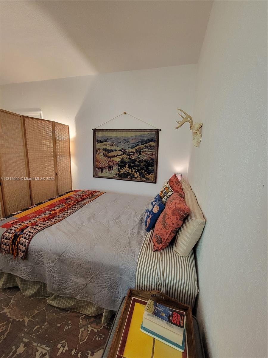 359 Meridian Avenue, Unit A103 Miami Beach, FL 33139 - Photo 10 of 22 a bedroom with a bed and a painting on the wall