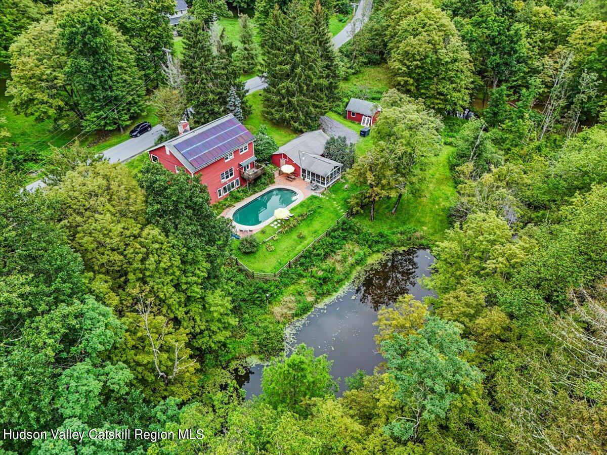 an aerial view of residential house with outdoor space and trees around