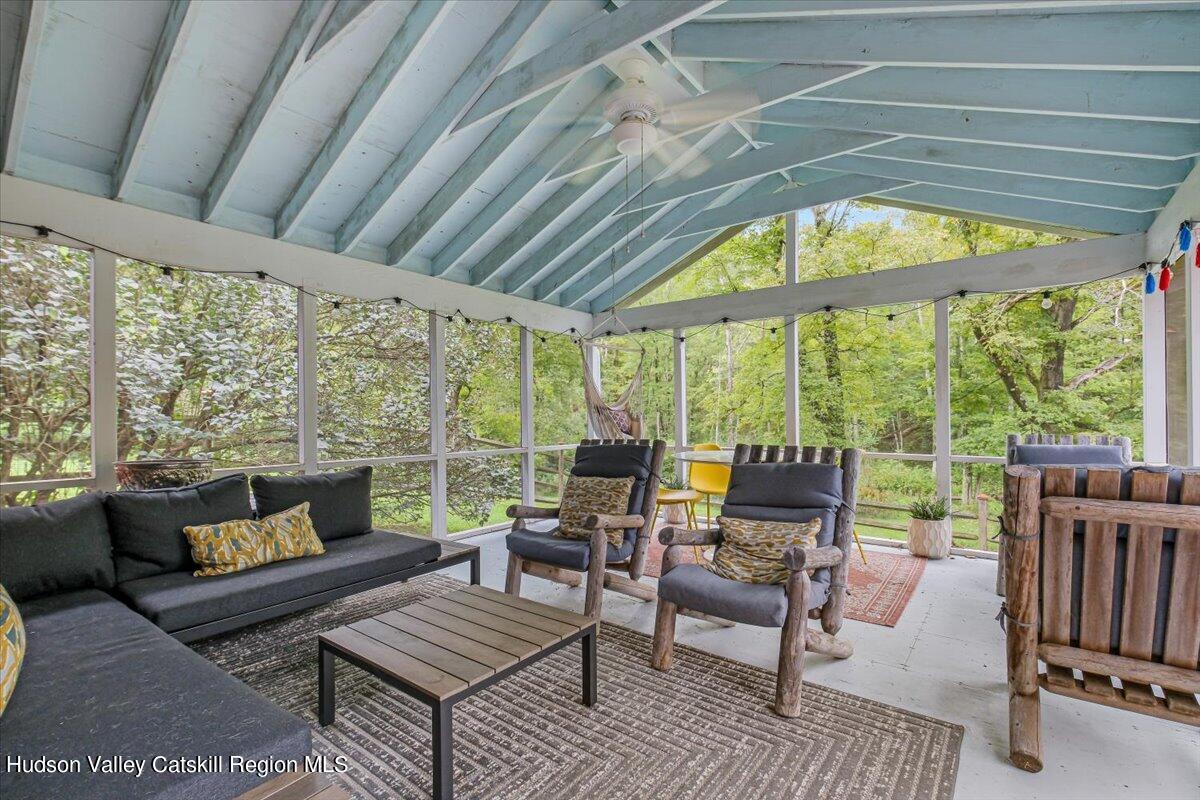 5 Longview Road Clinton, NY 12514 - Photo 38 of 44 a living room with furniture and a floor to ceiling window