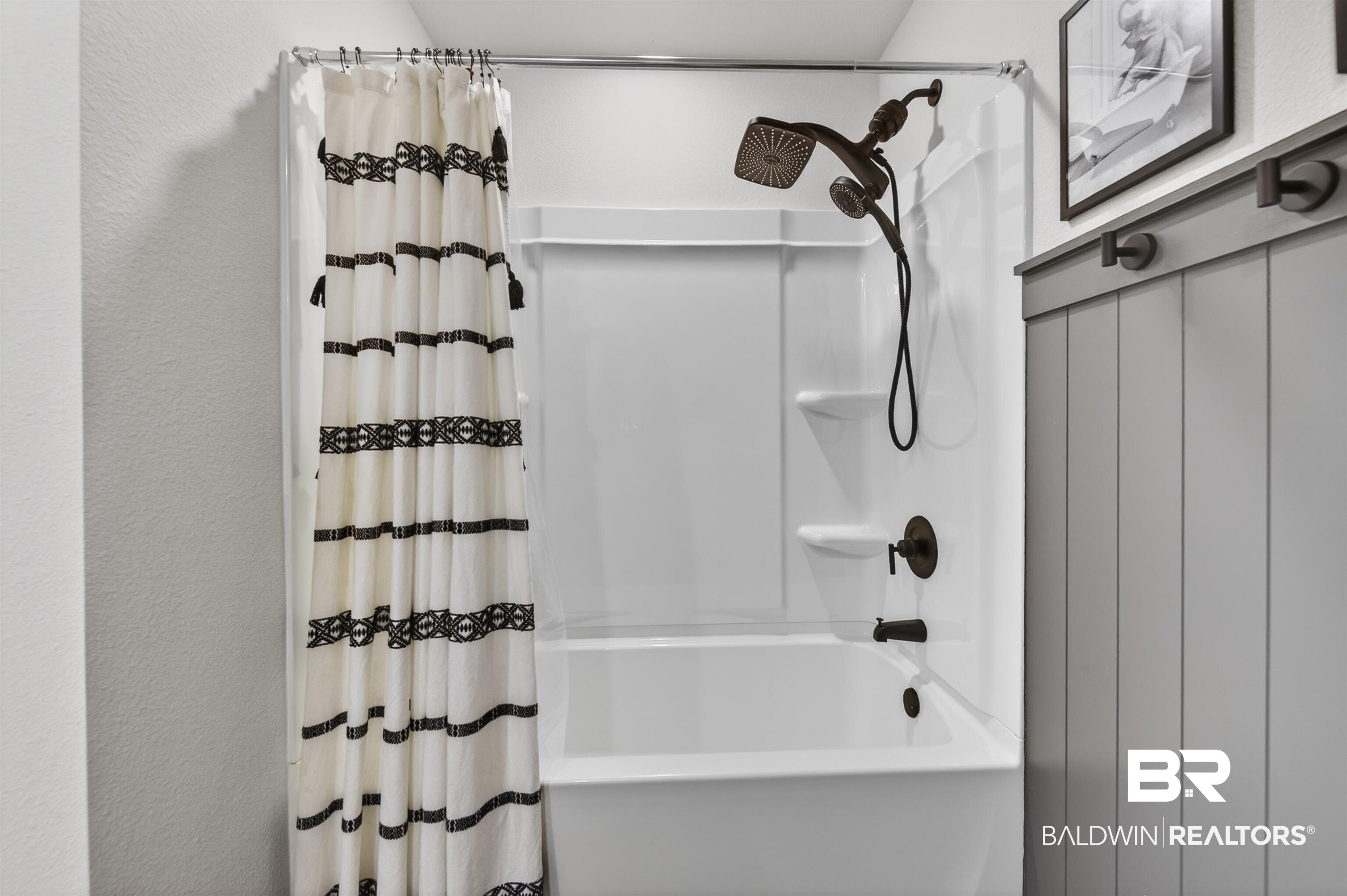 3213 Camino Real Loop Lillian, AL 36549 - Photo 51 of 61 White shower/tub combination featuring a two-in-one shower head and dark bronze fixtures