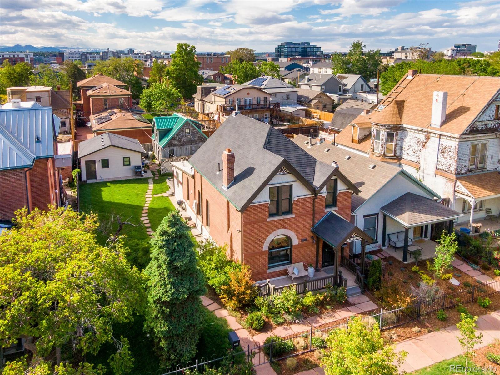 2815 Curtis Street Denver, CO 80205 - Photo 1 of 48 an aerial view of residential houses with outdoor space and trees