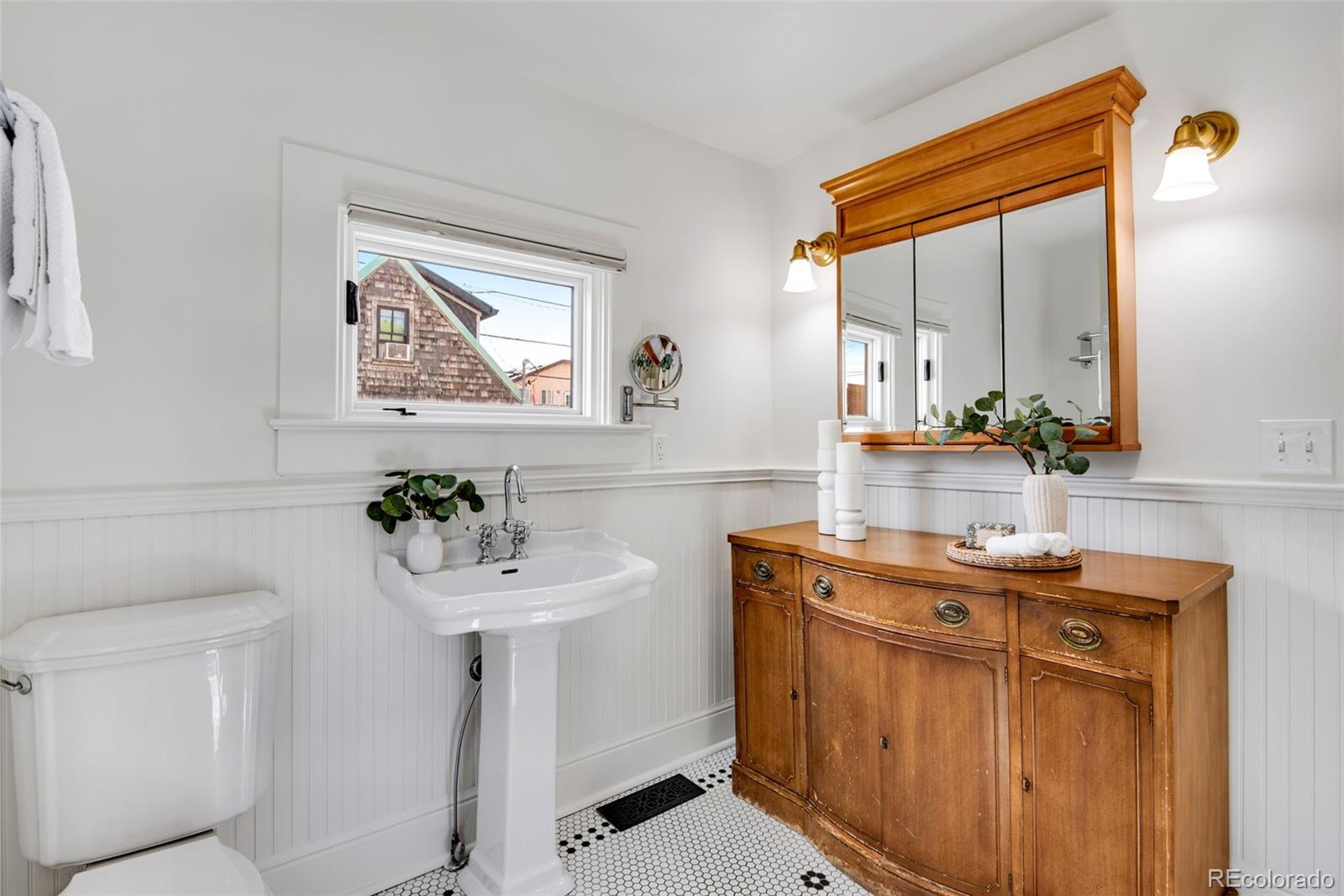 2815 Curtis Street Denver, CO 80205 - Photo 18 of 48 a bathroom with a sink and a mirror