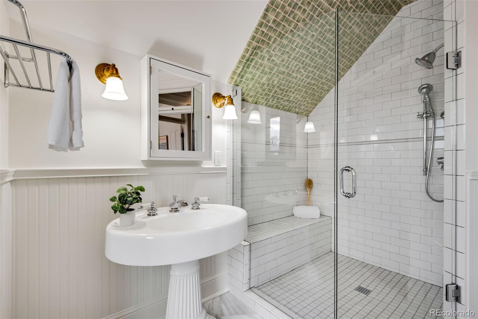 2815 Curtis Street Denver, CO 80205 - Photo 24 of 48 a bathroom with a sink and shower