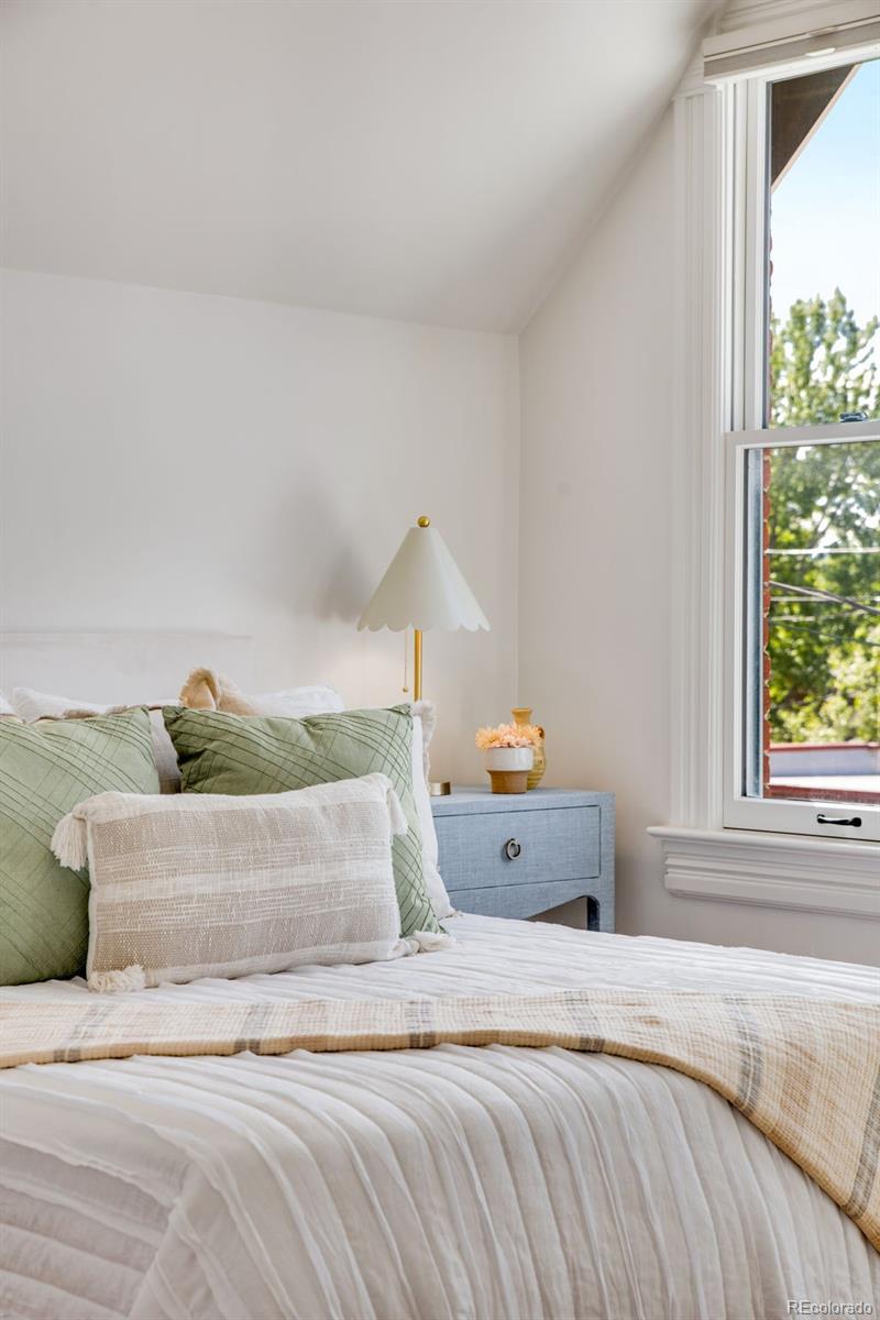 2815 Curtis Street Denver, CO 80205 - Photo 27 of 48 a bedroom with a bed and window