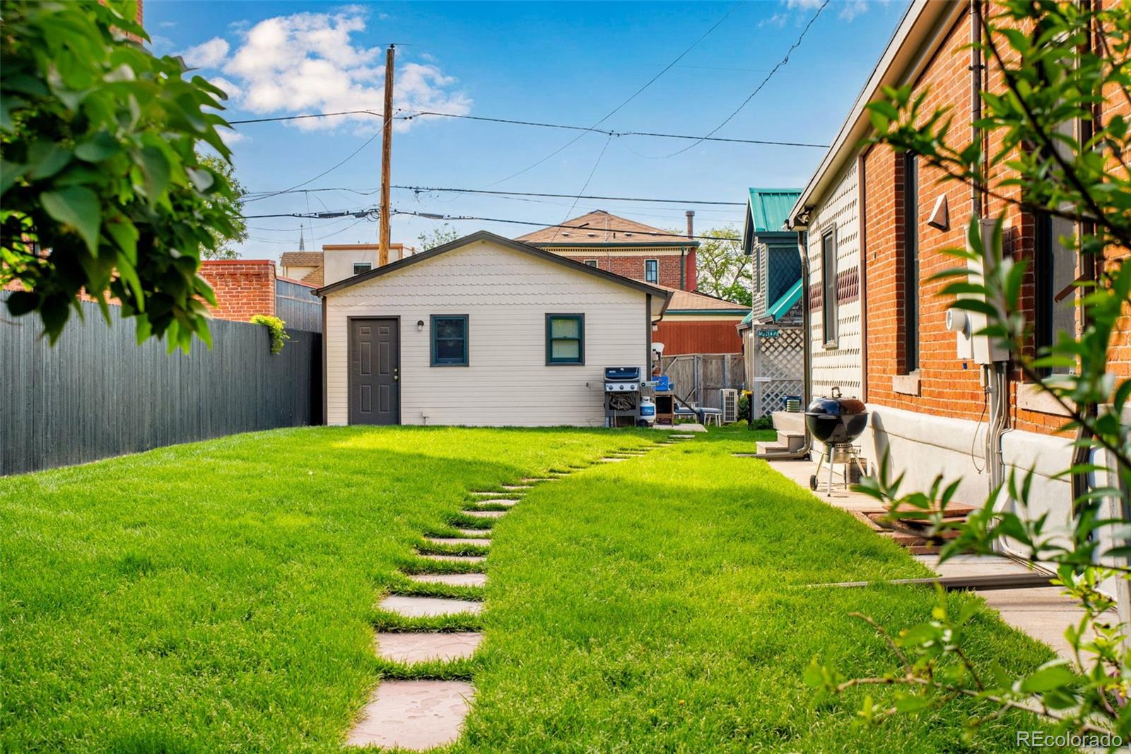 2815 Curtis Street Denver, CO 80205 - Photo 29 of 48 a front view of a house with a yard