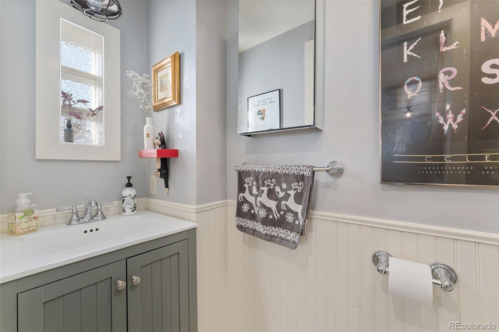 2815 Curtis Street Denver, CO 80205 - Photo 37 of 48 a bathroom with a sink mirror and vanity