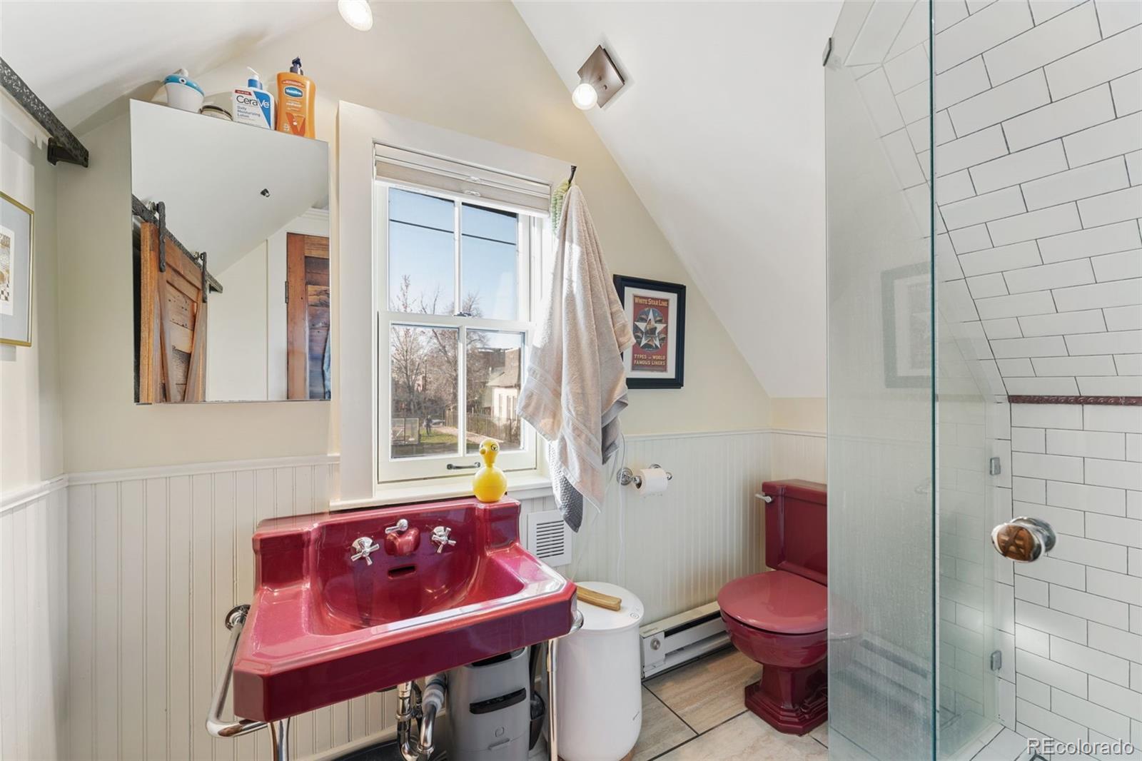 2815 Curtis Street Denver, CO 80205 - Photo 39 of 48 a bathroom with a sink toilet and shower